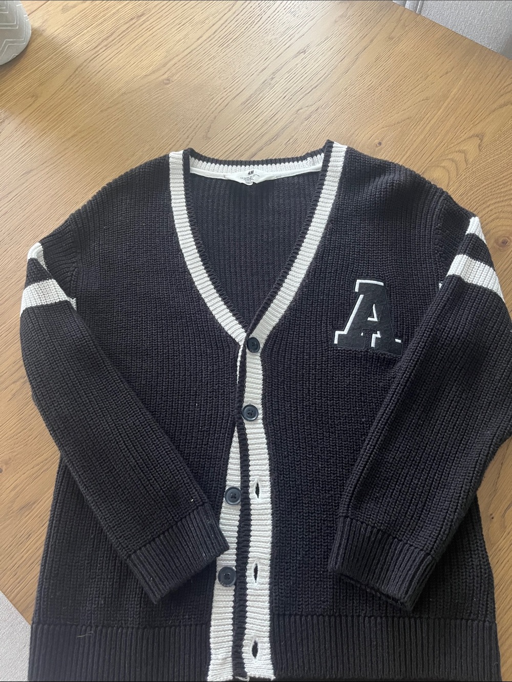 H&M Black Cardigan with White Trim and 'A' Patch